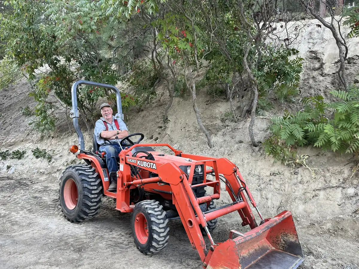 A Purpose Built Construction crew member on a tractor at a North Idaho job site